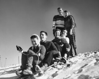 Group of friends tobogganing